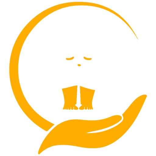 A child sitting with their head bowed over their knees, held in an open hand.